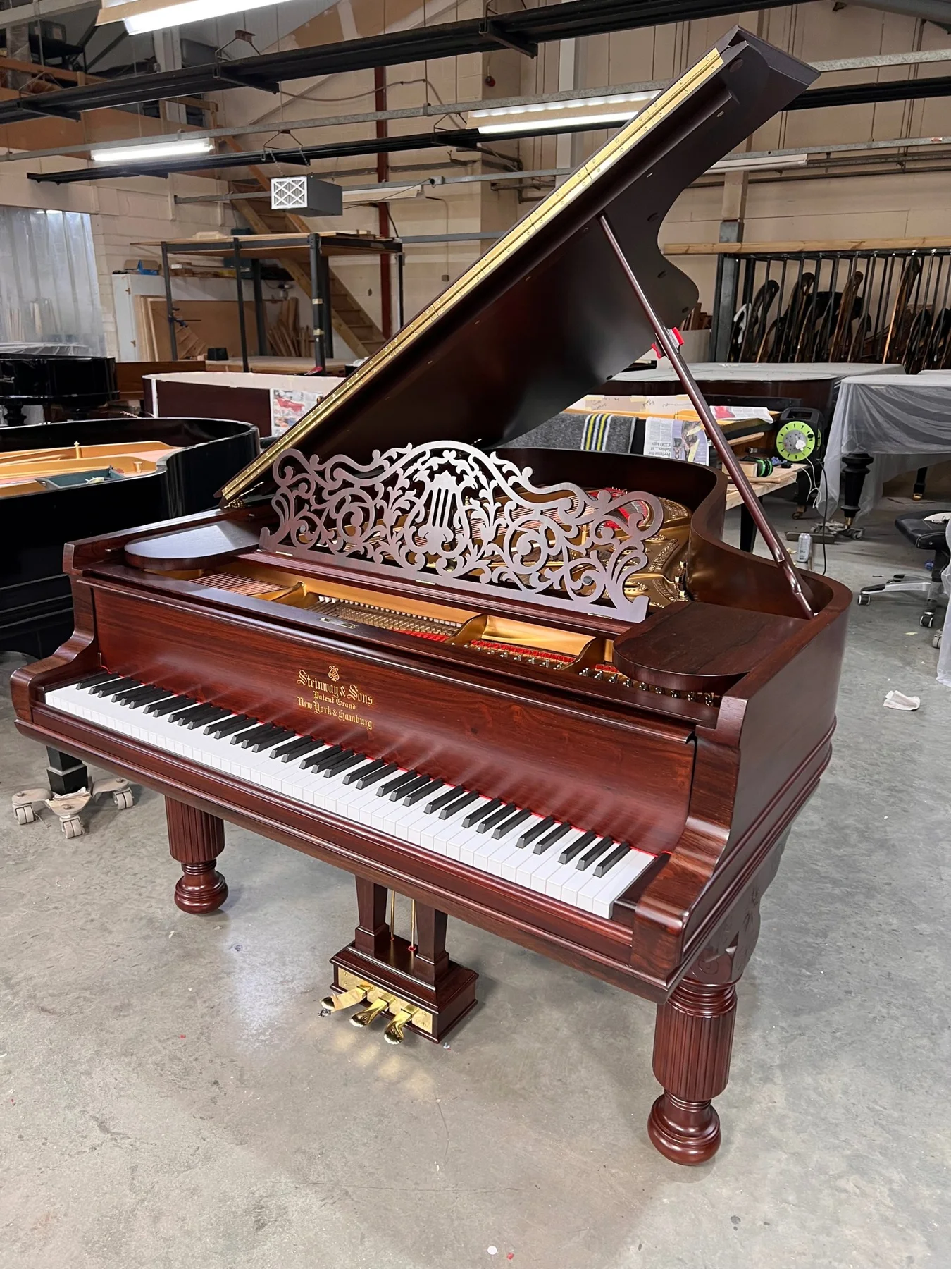 A restored Steinway grand piano in the Leverett workshop