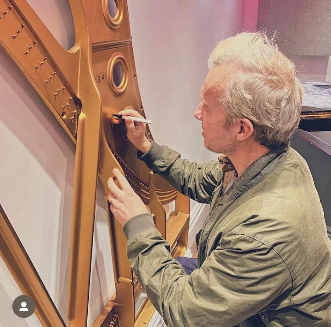 Signing a frame of fame - photograph from Piano Restorations